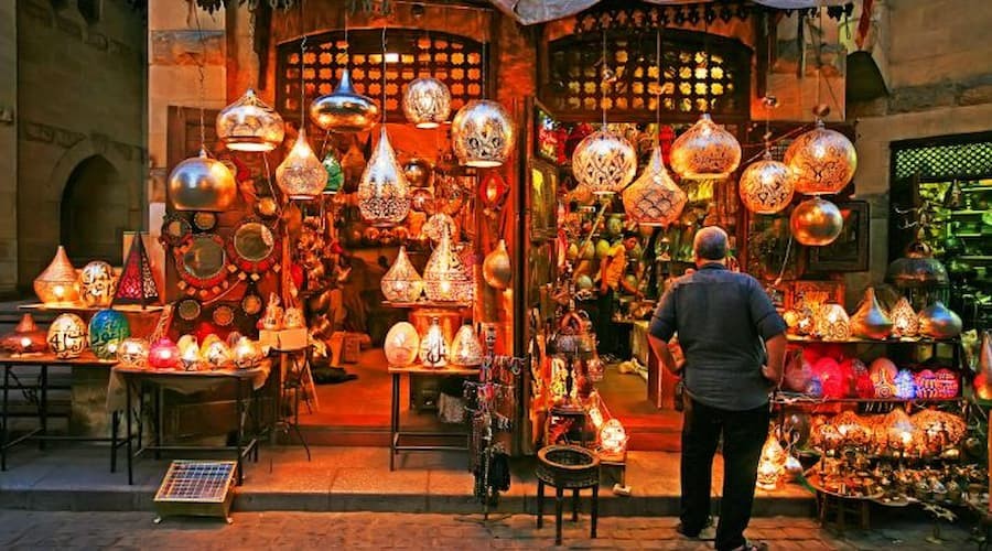 Bustling streets of Khan El Khalili Bazaar in Cairo filled with colorful shops, souvenirs, and local crafts